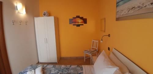 מיטה או מיטות בחדר ב-Casa vacanze Osvaldo