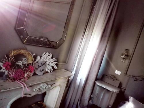 a bathroom with a mirror and flowers on a counter at L'Antico Lido Venice in Venice-Lido