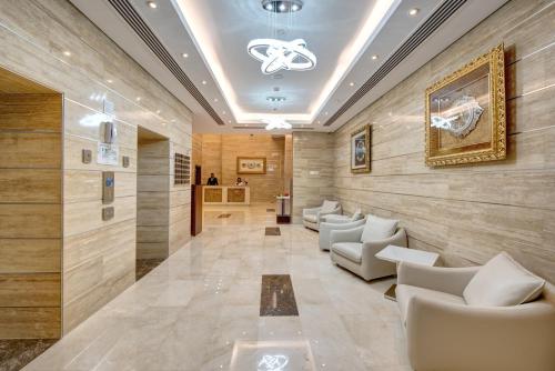 a lobby with couches and chairs in a building at Center Hotel Sharjah in Sharjah
