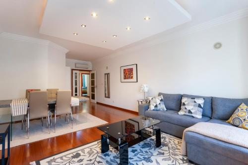 a living room with a couch and a table at luxury lisbon apartment T2 in Lisbon