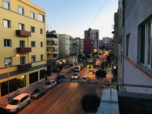 a city street with cars parked on the street at Port Side Rooms in Durrës