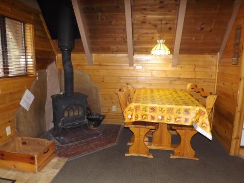 a dining room with a table and a stove at Arizona Mountain Inn & Cabins in Flagstaff