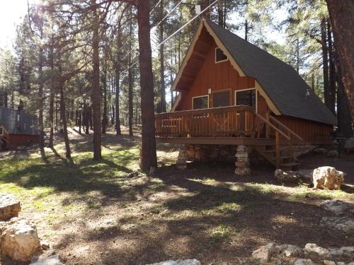 a cabin in the woods with a large deck at Arizona Mountain Inn & Cabins in Flagstaff