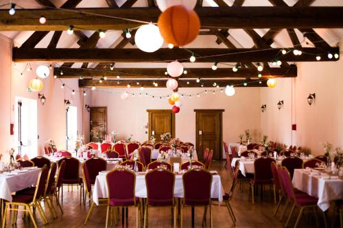 a banquet hall with tables and chairs and balloons at GITE DE LA BRETILLIERE in Les Menus