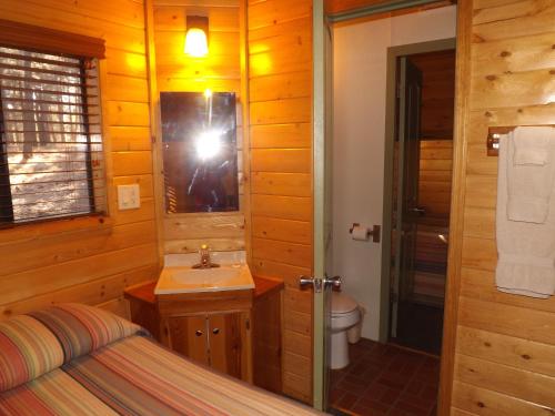 a photographer taking a picture of a bathroom in a log cabin at Arizona Mountain Inn & Cabins in Flagstaff