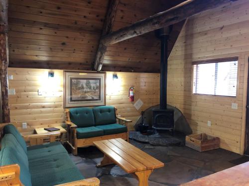 a living room with a couch and a stove at Arizona Mountain Inn & Cabins in Flagstaff
