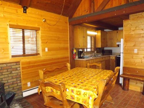a kitchen with a table in a wooden room at Arizona Mountain Inn & Cabins in Flagstaff