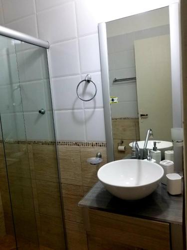 a bathroom with a sink and a glass shower at Pousada Boutique Recanto Do Encanto - GAMBOA - Morro de São Paulo in Morro de São Paulo
