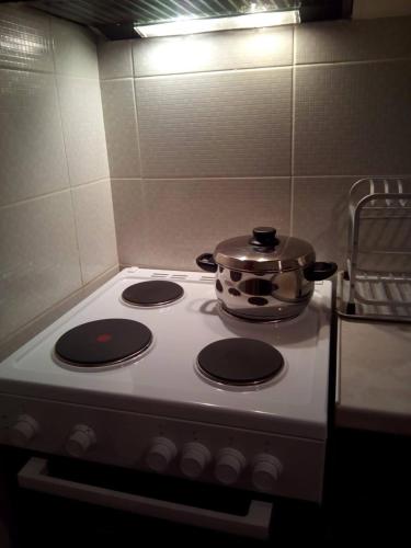 a pot sitting on top of a stove in a kitchen at Comfy Apartment near the Sea in Ierápetra