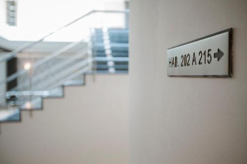 a sign on a wall next to a staircase at Hotel Alfonso I in Tui