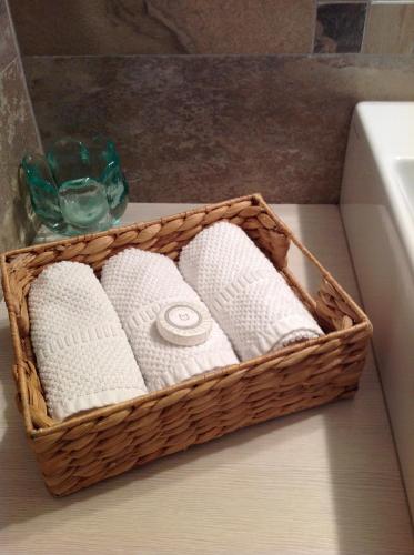 a basket of toilet paper sitting on a bathroom counter at Home White in Laives