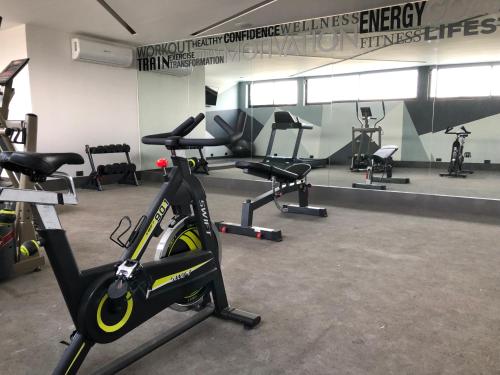 a gym with a bike and several exercise bikes at Hotel Isabel in Puebla