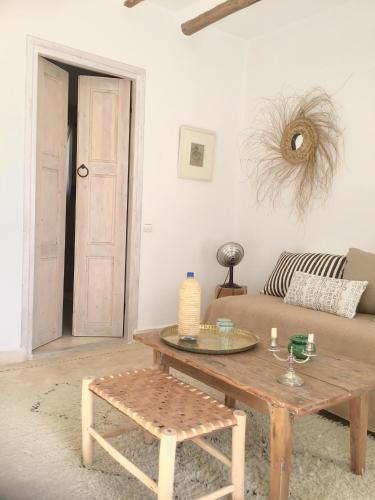 a living room with a coffee table and a couch at Dar Alya Essaouira Maison et table d'hôtes in Ghazoua