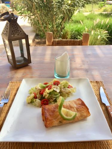 a plate of food with a salad and a piece of toast at Dar Alya Essaouira Maison et table d'hôtes in Ghazoua