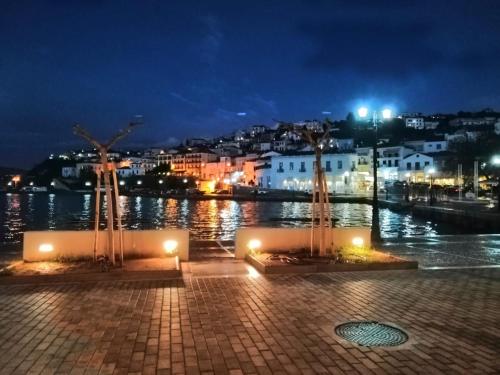 a view of a river at night with lights at Nestor's house in Pylos