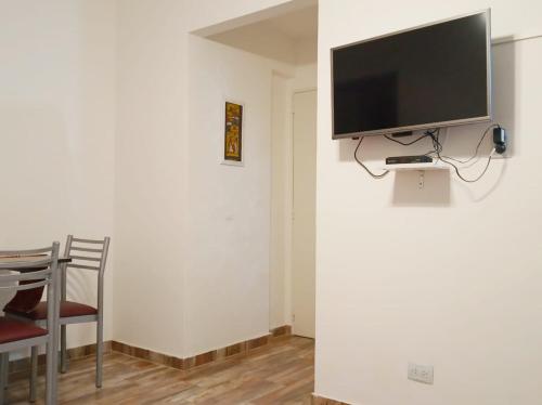 a living room with a television on a wall at Apartamento Buenos Aires in Buenos Aires