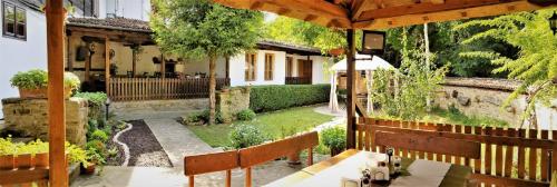 an outdoor patio with a table and benches at Yakovtsi Inn in Yakovtsi