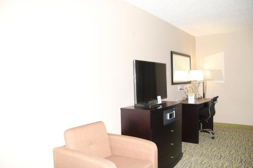 a hotel room with a couch and a tv and a chair at Super 8 by Wyndham Canmore in Canmore