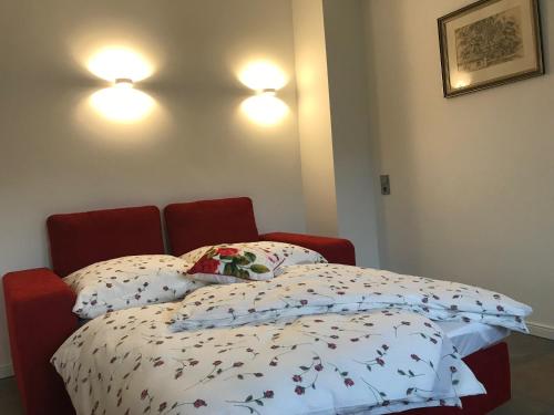 a bed in a room with two pillows on it at Zentrum Apartment Bad Schandau in Bad Schandau