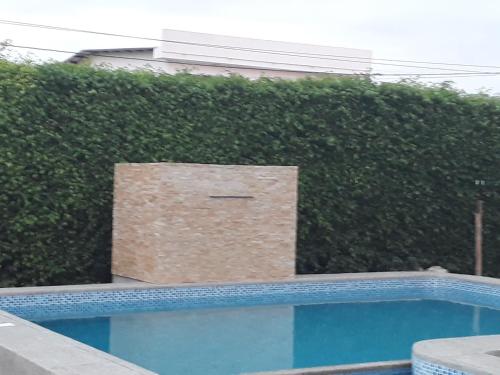 a box sitting on top of a hedge next to a swimming pool at Sol de Playa in Playas