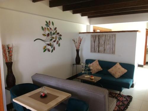 a living room with a couch and a table at Hotel El Giro in Villa de Leyva