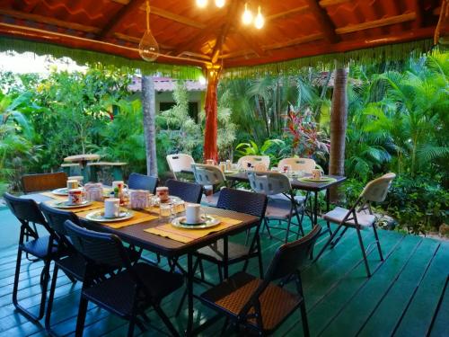 a wooden table and chairs on a deck with a table and chairsktop at Villas Verdes in Sámara
