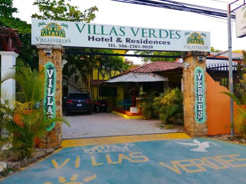 an entrance to a hotel with a sign that reads villas verdes hotel at Villas Verdes in Sámara
