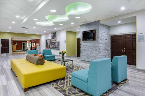 a lobby with a couch and chairs and a fireplace at Quality Inn and Suites Riverfront in Palatka