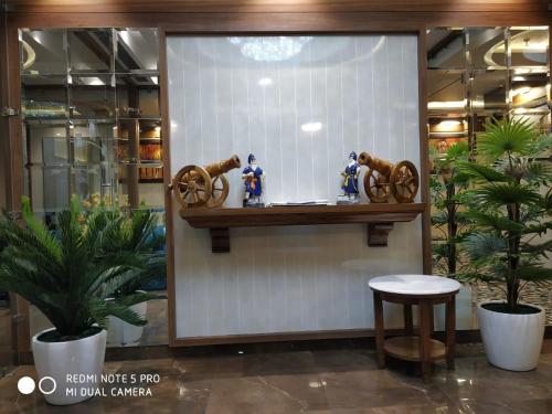 a display case in a store with figurines on a shelf at Hotel Makhan Residency in Amritsar