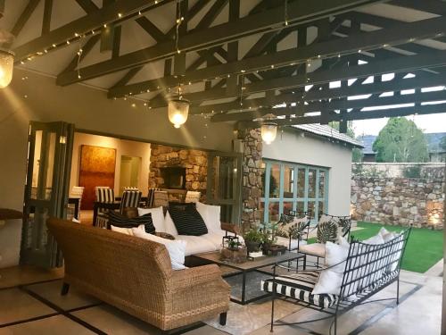 a living room with couches and a table at The Parkwood in Johannesburg