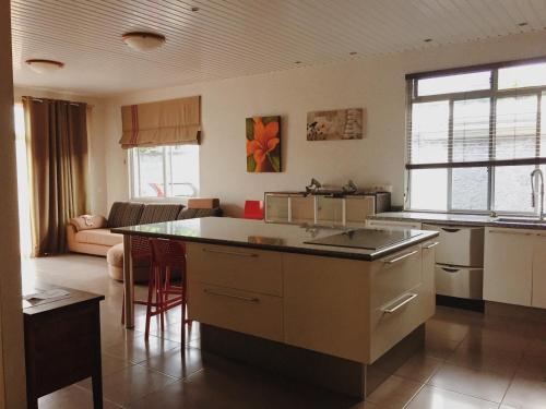 a kitchen with an island in the middle of a room at City Home Tahiti in Papeete
