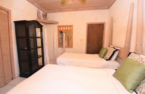 a room with two beds and a telephone at The Sugar Apple Lodging in Harbour Island
