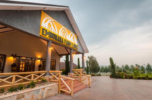 a restaurant with a sign on the side of a building at Emburara Farm Lodge in Mbarara