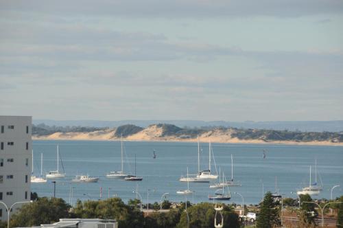 a group of boats in a large body of water at The Lord Forrest Hotel in Bunbury