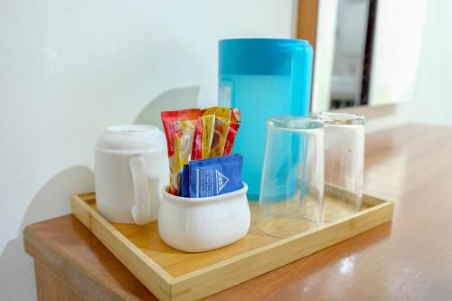 a wooden tray with some items on a table at Landcons Hotel & Resort in Pantai Cenang