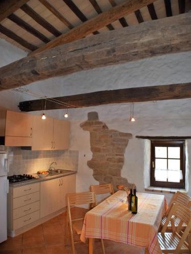 a kitchen with a table and chairs in a room at Agriturismo Alla Vecchia Quercia in Pergola