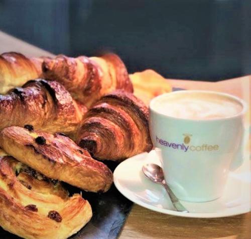 a plate of pastries next to a cup of coffee at Kings Park Hotel in Retford