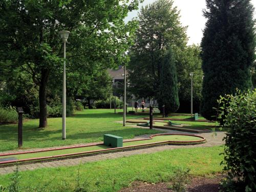 a park with benches and lights in the grass at Floreal La Roche-en-Ardenne in La Roche-en-Ardenne