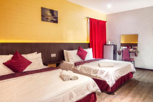Ένα ή περισσότερα κρεβάτια σε δωμάτιο στο Myvilla Langkawi Hotel