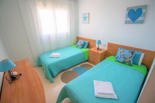 a small room with two beds and a table at Residence Vacanza Torre Monaco in Benidorm