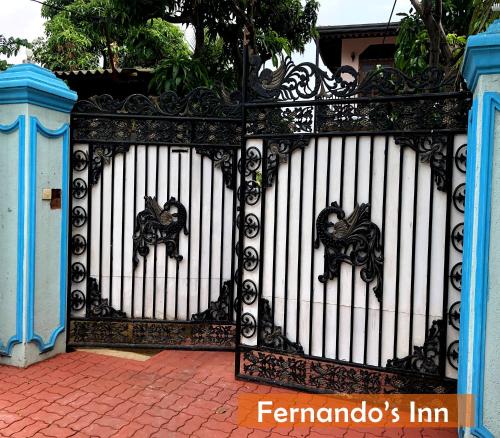 a black and white gate with a horse on it at Fernando's Inn in Negombo