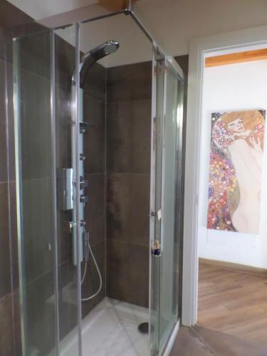 a shower with a glass door in a bathroom at La Briciola in Lesa