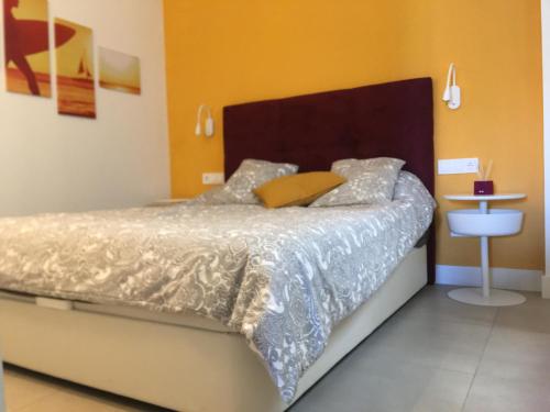 a bedroom with a bed with a wooden head board at Buddha house in Torrox Costa