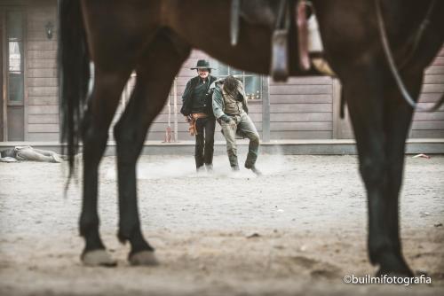a man and a woman standing next to a horse at Camping Fort Bravo in Tabernas
