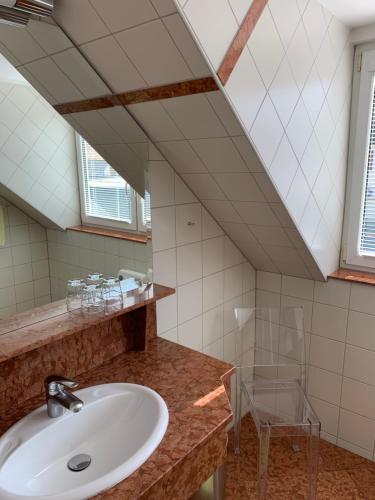 a bathroom with a sink and a mirror at Hotel Csejtei in Feldbach