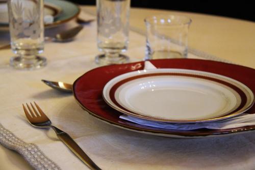 a red and white plate and fork on a table at La casa di Chiara in Diano dʼAlba