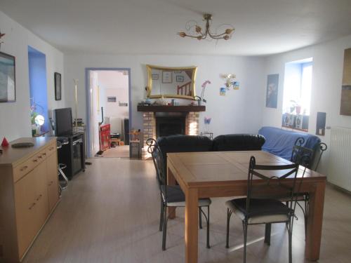 a dining room and living room with a table and chairs at chambres d'hôtes les mésanges avec salle d'eau privative pdj compris in Kersaint-Plabennec