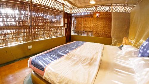 a bedroom with a large bed in a room at Beach Street Eco Resort - Mandrem in Mandrem