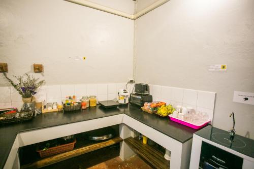 a kitchen with a black counter top in a room at Barn1920s Hostel in Vientiane