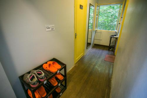 a hallway with a shelf with shoes in a room at Barn1920s Hostel in Vientiane